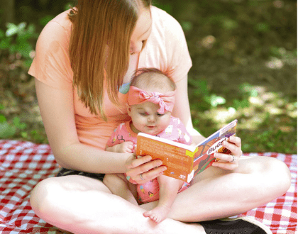 This is a photo of a mom reading to a baby